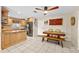 Eat-in kitchen with wood cabinets, tile floors, granite countertops, and modern stainless steel appliances at 8083 Bayhaven Dr, Seminole, FL 33776