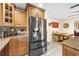 Kitchen with stainless steel refrigerator, granite countertops, and view into dining area at 8083 Bayhaven Dr, Seminole, FL 33776