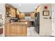 Well-lit kitchen with stainless steel appliances, wooden cabinets, and tile flooring at 8083 Bayhaven Dr, Seminole, FL 33776