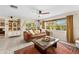 Bright living room featuring a large window, comfortable seating, and tile flooring at 8083 Bayhaven Dr, Seminole, FL 33776