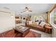 Open living space featuring a large couch, tile floors, and access to the outdoor patio at 8083 Bayhaven Dr, Seminole, FL 33776