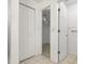 Bathroom showing linen closet, walk-in closet, and doorway at 8509 N 13Th St, Tampa, FL 33604