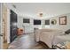 Cozy bedroom with wood-look floors, two windows, a ceiling fan, and a comfortable orange chair at 1013 E North St, Tampa, FL 33604