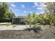 A well-landscaped front yard showcasing decorative rock and mulch surrounding a cute single-story home at 1013 E North St, Tampa, FL 33604