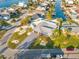 Aerial view of a landscaped single-story house featuring a driveway, a beautiful lawn, and waterfront access at 1029 Bal Harbour Dr, Apollo Beach, FL 33572