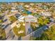 Birds eye view of a waterfront home with a lush green lawn, nicely manicured landscaping, and a large driveway at 1029 Bal Harbour Dr, Apollo Beach, FL 33572