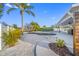 Beautiful backyard with a pool, covered patio, and tropical landscaping at 1029 Bal Harbour Dr, Apollo Beach, FL 33572
