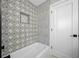 Charming bathroom featuring decorative tile surround, shower niche, and soaking tub at 1029 Bal Harbour Dr, Apollo Beach, FL 33572