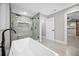 Modern bathroom featuring a soaking tub, glass-enclosed shower, and stylish tile work at 1029 Bal Harbour Dr, Apollo Beach, FL 33572