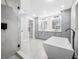 Modern bathroom boasting a glass enclosed shower, soaking tub and double vanity at 1029 Bal Harbour Dr, Apollo Beach, FL 33572