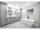 Bright bathroom with double vanity, freestanding tub, and modern fixtures at 1029 Bal Harbour Dr, Apollo Beach, FL 33572