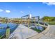 Waterfront view of the boat lift and dock with clear blue skies providing a luxurious outdoor experience at 1029 Bal Harbour Dr, Apollo Beach, FL 33572