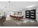 Bright dining room with a modern table, stylish seating, and a black framed glass door leading to the patio at 1029 Bal Harbour Dr, Apollo Beach, FL 33572