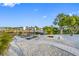 Waterfront backyard with a dock, boat lift, and fire pit area at 1029 Bal Harbour Dr, Apollo Beach, FL 33572