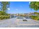 Backyard featuring a canal, boat lift, dock, fire pit, and white gravel landscaping at 1029 Bal Harbour Dr, Apollo Beach, FL 33572