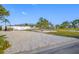 Gravel driveway leading to a well-maintained property, offering ample parking space and curb appeal at 1029 Bal Harbour Dr, Apollo Beach, FL 33572
