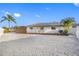 Exterior shot showing a well-maintained yard and the home's facade with gravel landscaping at 1029 Bal Harbour Dr, Apollo Beach, FL 33572
