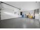 Spacious garage with a gray epoxy floor, perfect for parking and storage at 1029 Bal Harbour Dr, Apollo Beach, FL 33572