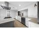 Modern kitchen featuring white cabinets, sleek countertops, stainless appliances, and an island, perfect for culinary enthusiasts at 1029 Bal Harbour Dr, Apollo Beach, FL 33572
