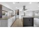 Well-lit open kitchen with white cabinetry, a large island, stainless steel appliances, and wood-look flooring at 1029 Bal Harbour Dr, Apollo Beach, FL 33572