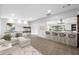 Open-concept living room with breakfast bar, comfortable seating, and modern decor at 1029 Bal Harbour Dr, Apollo Beach, FL 33572