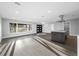 Expansive living space featuring wood floors, an open kitchen with a large island, and a sliding glass door leading outside at 1029 Bal Harbour Dr, Apollo Beach, FL 33572
