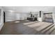 Open-concept living space with wood-look floors, an island kitchen, and multiple entryways, creating a welcoming atmosphere at 1029 Bal Harbour Dr, Apollo Beach, FL 33572