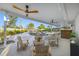 A covered patio with ceiling fans, outdoor furniture, and a view of the pool at 1029 Bal Harbour Dr, Apollo Beach, FL 33572