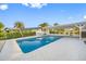 A backyard pool with a covered patio and white brick surround at 1029 Bal Harbour Dr, Apollo Beach, FL 33572