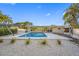 Backyard showcasing a stunning pool, white gravel landscaping, and a covered patio area at 1029 Bal Harbour Dr, Apollo Beach, FL 33572