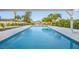 The pool is surrounded by a brick patio, landscaping, and views of the waterfront at 1029 Bal Harbour Dr, Apollo Beach, FL 33572