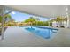Beautiful pool under a covered patio with a view of the water at 1029 Bal Harbour Dr, Apollo Beach, FL 33572