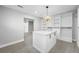 Bright walk-in closet featuring custom shelving and a central island for storage at 1029 Bal Harbour Dr, Apollo Beach, FL 33572
