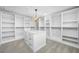 Spacious walk-in closet with custom shelving and drawers, offering ample storage space at 1029 Bal Harbour Dr, Apollo Beach, FL 33572