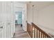 Bright hallway with hardwood floors, white trim, and stylish décor throughout the home at 110 Woods Landing Trl, Oldsmar, FL 34677