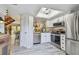 Well-lit kitchen with stainless steel appliances, white cabinets, and modern lighting at 110 Woods Landing Trl, Oldsmar, FL 34677