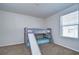 Bedroom with a bunk bed and slide, offering a fun and playful space with a window for natural light at 11117 Abaco Island Ave, Riverview, FL 33579