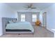 This bedroom features a ceiling fan, windows and plush carpeting at 11117 Abaco Island Ave, Riverview, FL 33579