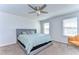 This bedroom features a ceiling fan, windows and plush carpeting at 11117 Abaco Island Ave, Riverview, FL 33579