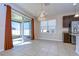 Open dining area boasts sliding glass doors to backyard, tile flooring, and chandelier at 11117 Abaco Island Ave, Riverview, FL 33579