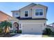 Charming two-story home featuring an attached two-car garage and well-manicured landscaping at 11117 Abaco Island Ave, Riverview, FL 33579