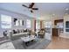 Staged living room that flows into the dining area and kitchen, perfect for modern living at 11117 Abaco Island Ave, Riverview, FL 33579
