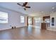 Spacious living room featuring laminate floors that flows into the kitchen and dining room at 11117 Abaco Island Ave, Riverview, FL 33579