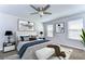 This main bedroom provides comfort and elegance with a ceiling fan and artwork at 11117 Abaco Island Ave, Riverview, FL 33579
