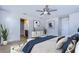 This bedroom features a ceiling fan, ensuite bathroom and decorative art creating a cozy retreat at 11117 Abaco Island Ave, Riverview, FL 33579