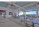 Spacious outdoor lounge area with ceiling fans, fireplace, tv and lovely waterfront views and comfortable seating at 11117 Abaco Island Ave, Riverview, FL 33579