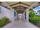 Covered walkway featuring tile flooring, beautiful landscaping, and view of the pool at 11117 Abaco Island Ave, Riverview, FL 33579
