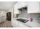 The kitchen features a modern electric stove, a sleek grey backsplash, and white cabinets at 11501 Cedar Valley Dr, Riverview, FL 33569