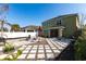 This backyard has a unique stone pattern, a grill, an umbrella, and plenty of space to relax and entertain at 11539 Tangle Branch Ln, Gibsonton, FL 33534