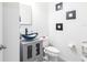 Modern bathroom with a unique vessel sink, gray vanity, and contemporary square wall decor at 11539 Tangle Branch Ln, Gibsonton, FL 33534